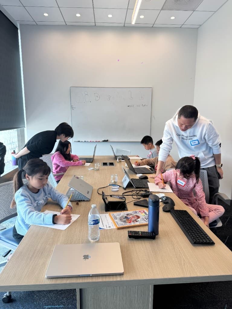 Instructor helping students with Storybook worksheets at the table