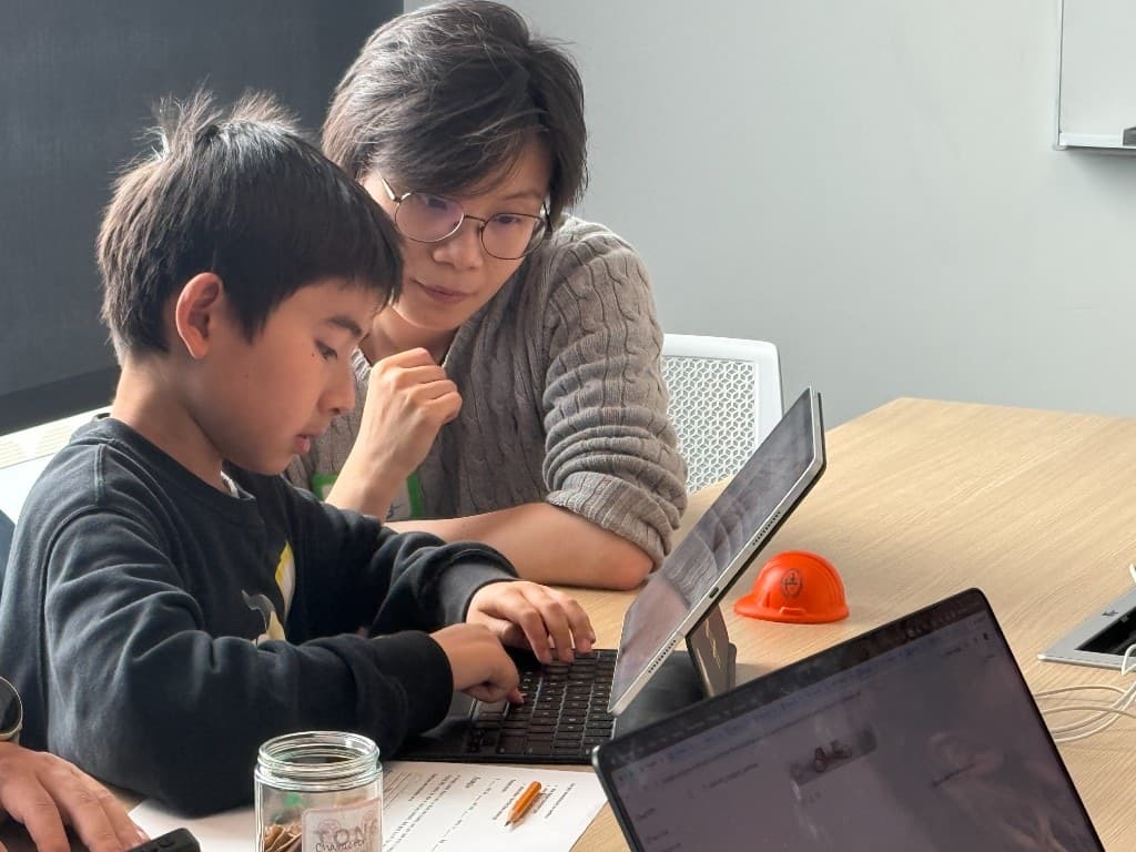Student presenting an AI-illustrated character on the big screen