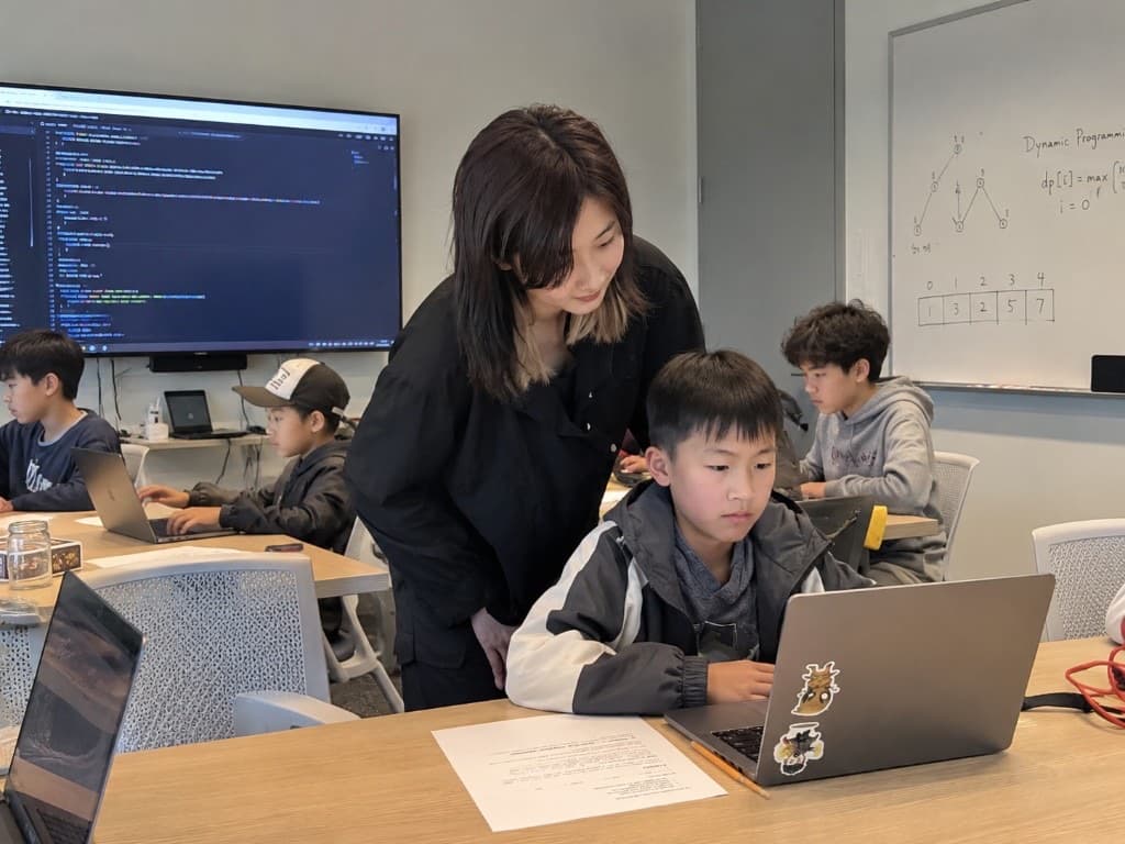 Mentor helping a student with their project during Vibe Coding