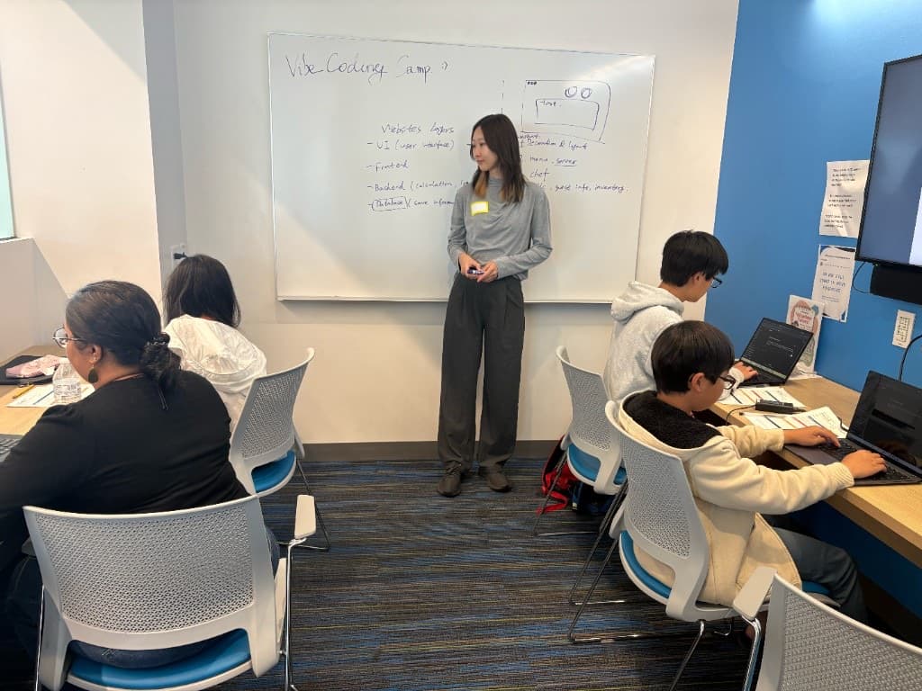 Instructor teaching website layers at the whiteboard during Vibe Coding Camp