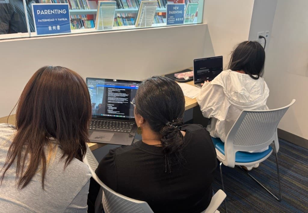 Students collaborating on a product requirements document