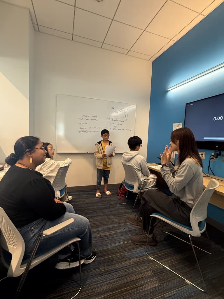 Student presenting website layers to the group during Vibe Coding