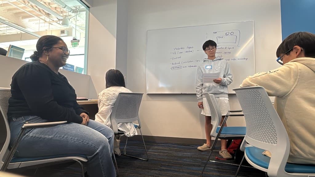 Student presenting website architecture notes to the group