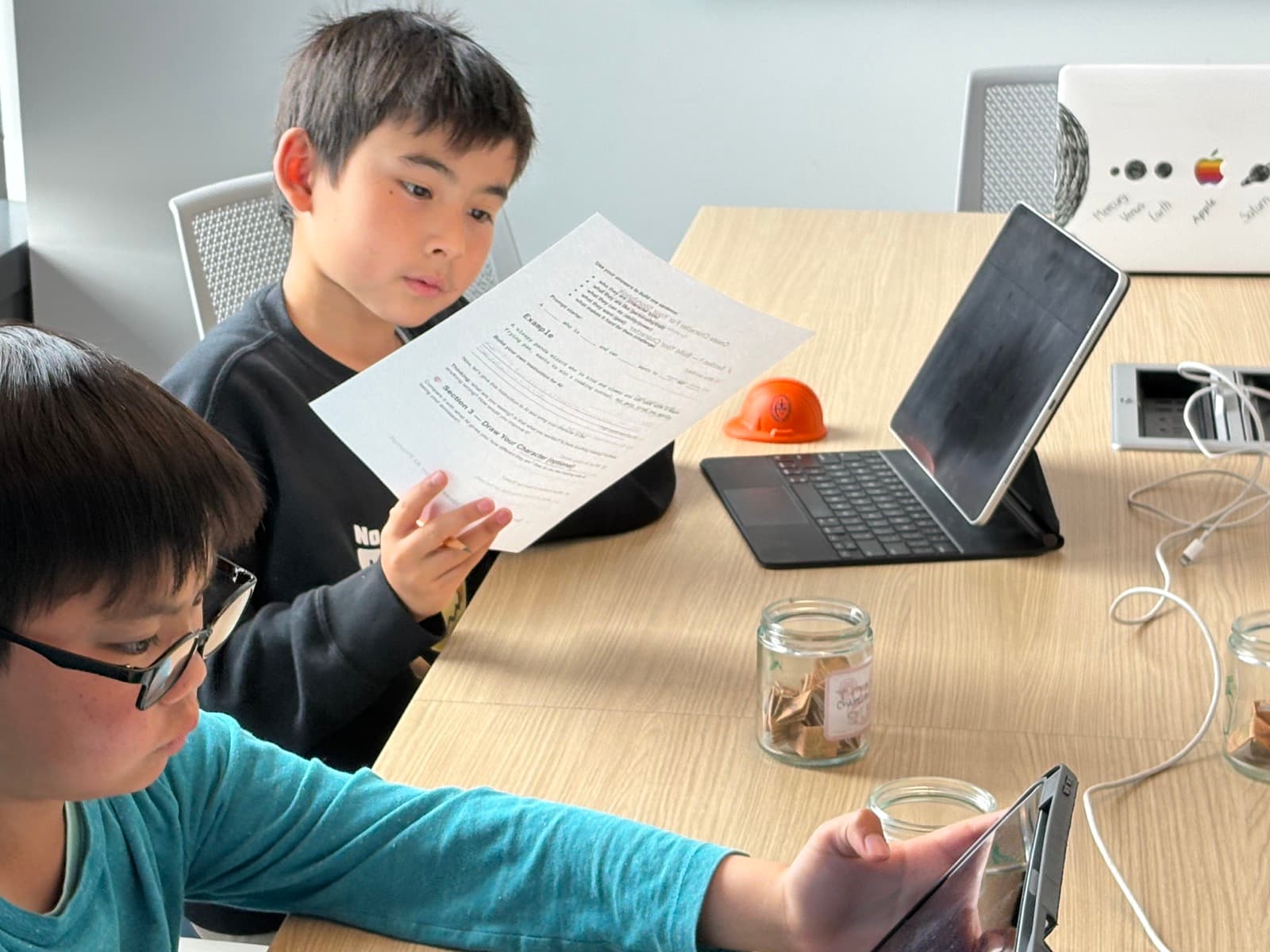 Students working on worksheets and tablets during a Bay Area class